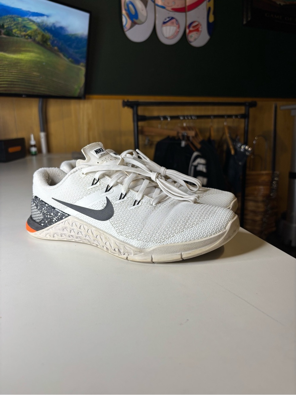 white Nike Metcon 4 women's training shoes with a black swoosh